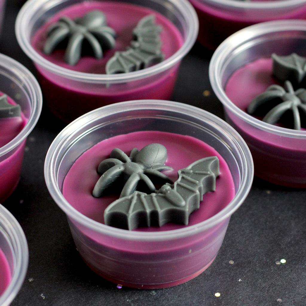 Dark pink wax melt cups with spider and bat decorations