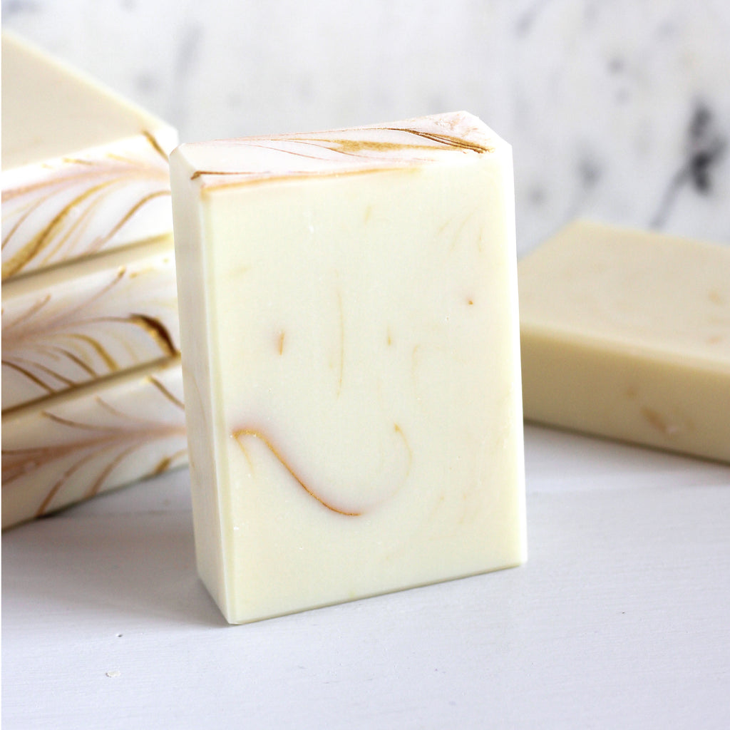 White and gold soap bars on a marble background