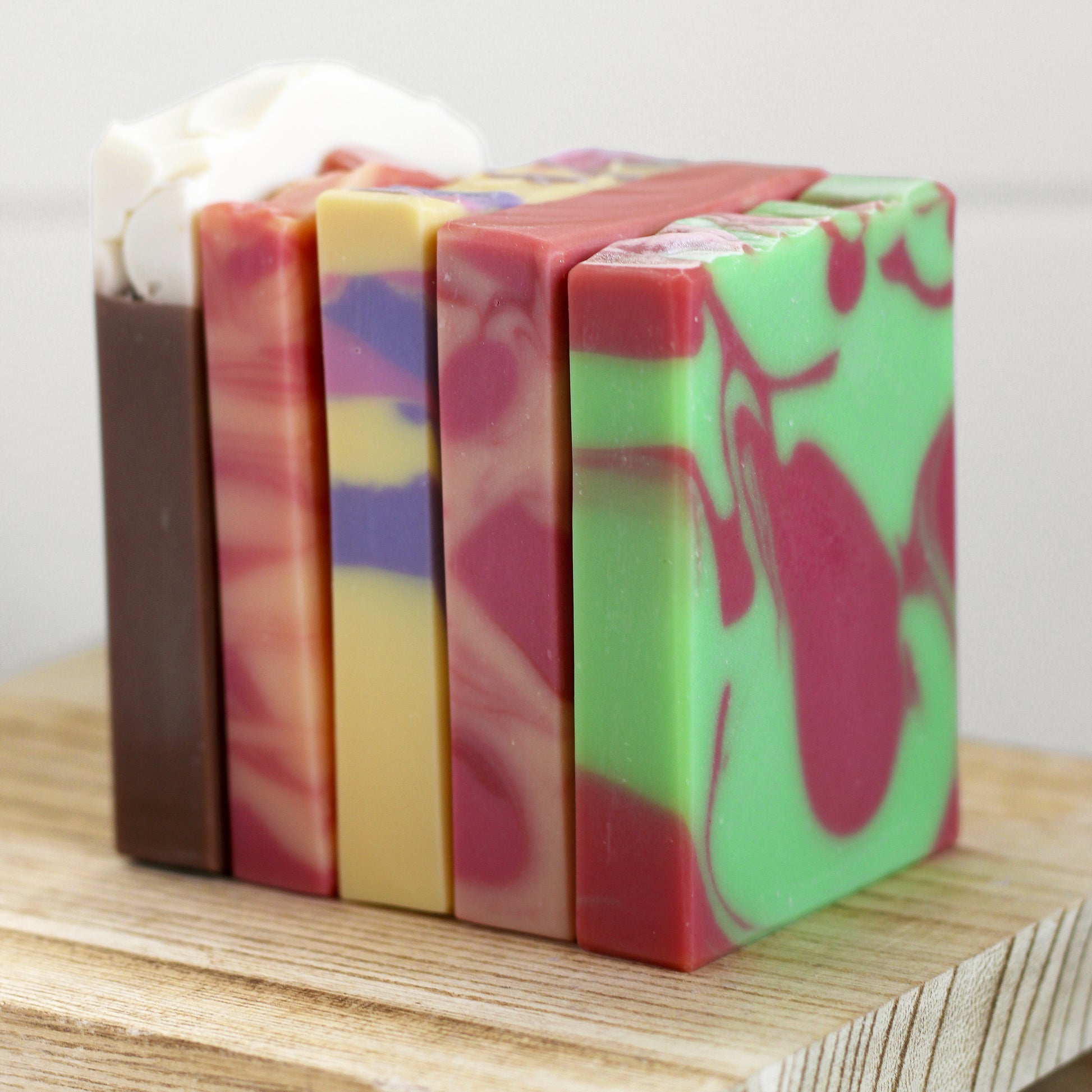July Soap Sampler featuring five handcrafted cold process soaps: Berry Lemonade, Cranberry Limeade, Peach Mango Sangria, Root Beer Float, and Strawberry Sweet Tea, arranged together in a limited-edition summer collection by Missouri River Soap.