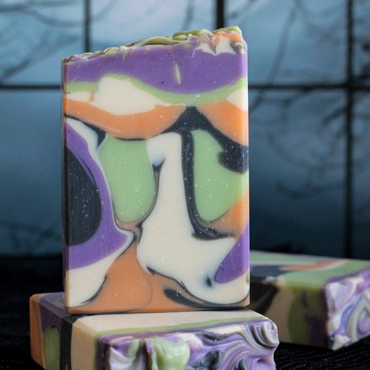 Colorful Halloween soap bars with swirls of purple, green, orange, black, and cream.