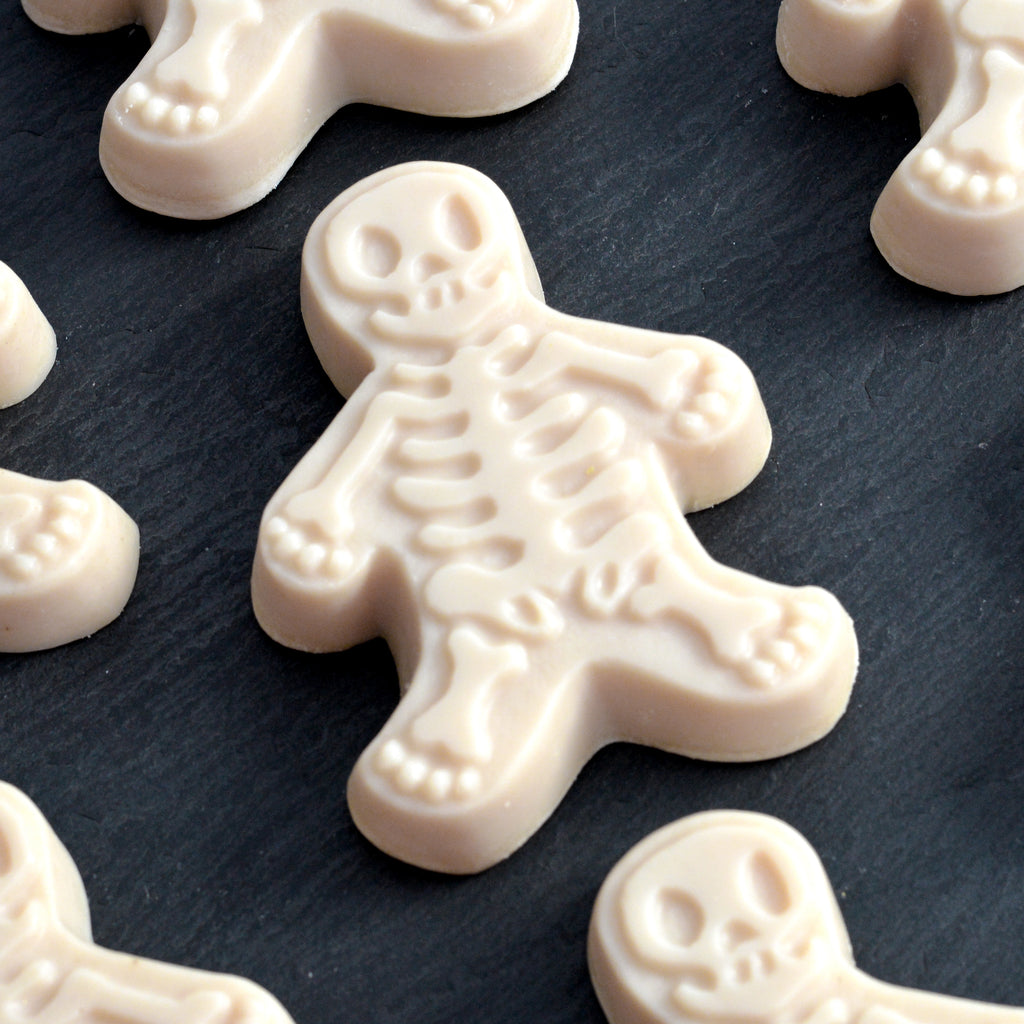 Skeleton soaps on a dark slate surface