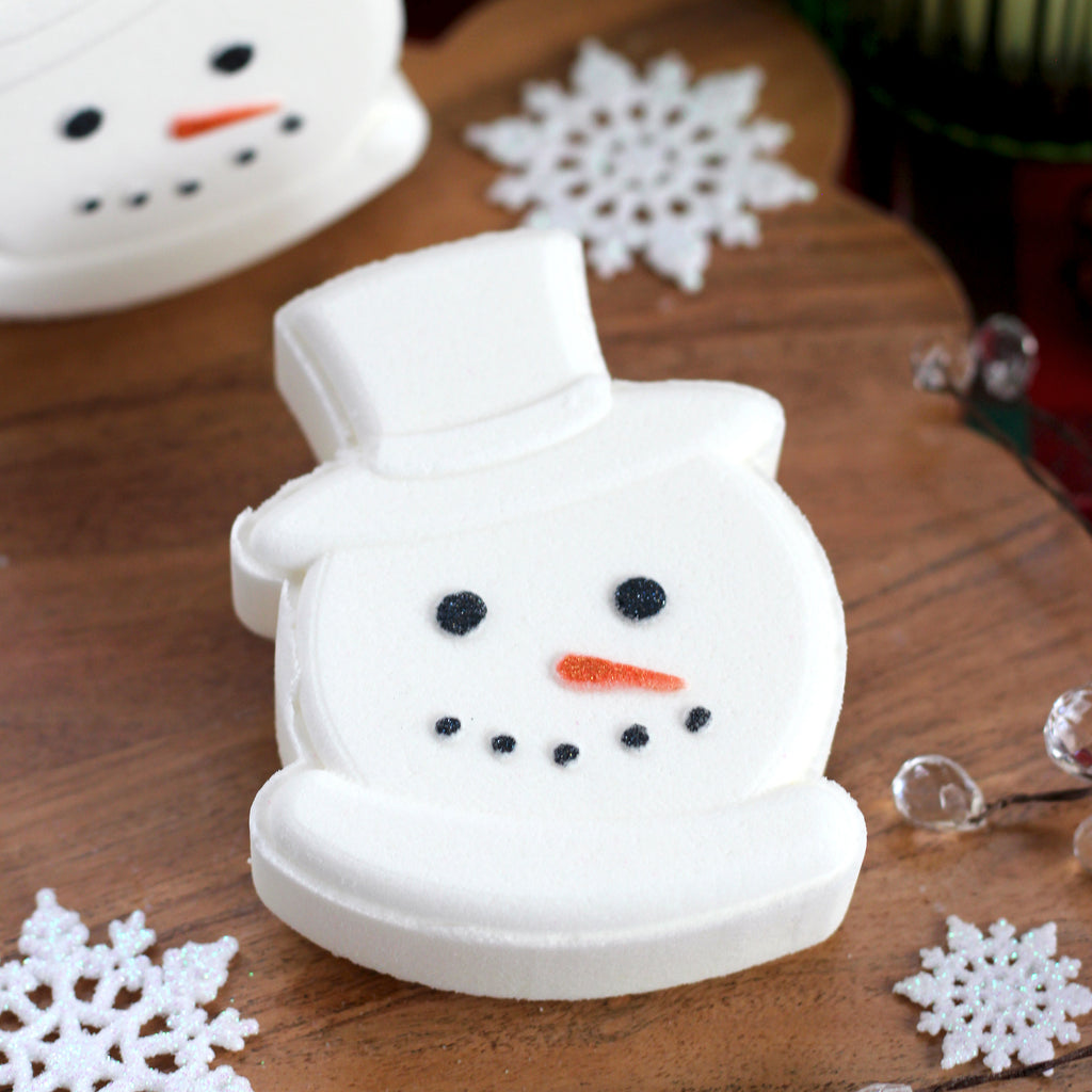 Missouri River Soap Coconut Snowball Bath Bomb – handcrafted white snowman head with mica-painted eyes, nose, and mouth; sweet fragrance of honey, coconut, caramel, monk fruit, brown sugar, and vanilla bean.