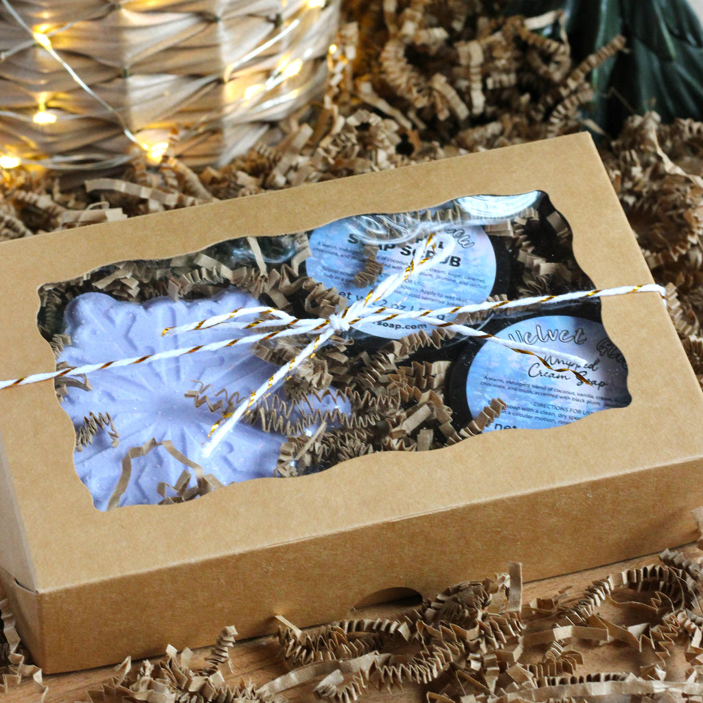 Three Velvet Glow products in a box wrapped with a string.