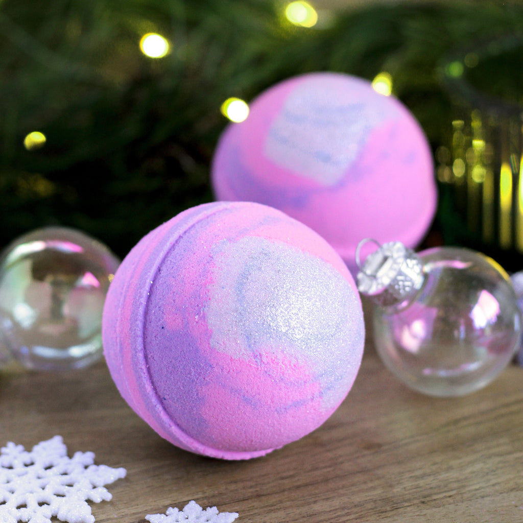 Missouri River Soap Snow Kissed Bath Bomb – handcrafted round bath bomb in shades of pink and purple, flirty fragrance blend of cherry, pear, vanilla, and cotton candy.